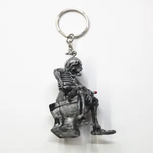 Detailed view of a unique skeleton sitting on a toilet keychain for Halloween