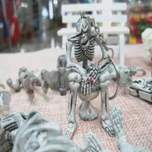 Detailed view of creative skeleton sitting on a toilet keychain for Halloween