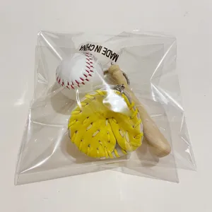 Detail view of baseball keychain set with mini glove and bat in clear packaging