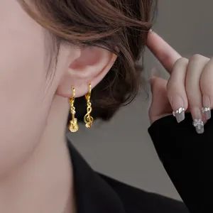 Asymmetrical gold guitar and musical note hoop earrings with rhinestones