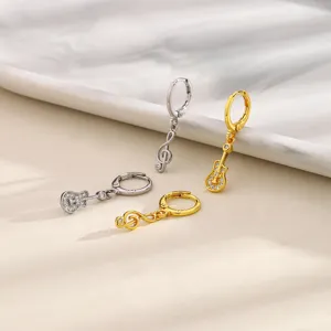 Asymmetric music note and guitar hoop earrings featuring sparkling cubic zirconia pavé