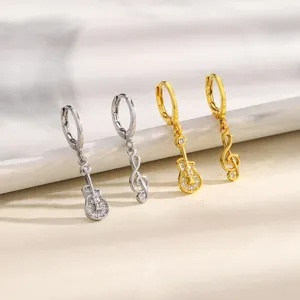 Silver and gold asymmetric hoop earrings with guitar and musical note dangling charms