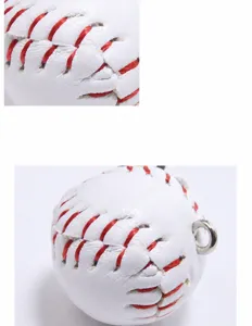 Close-up detail of a mini baseball keychain with red stitching and leather texture