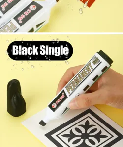 Close-up view of black permanent marker tip used for detailing and coloring on card.
