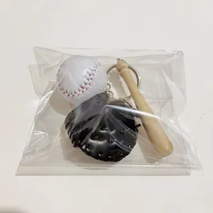 Macro detail of a three-piece baseball keychain set with mini bat and glove in a polybag