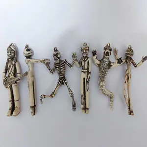 Detailed close-up showing six unique vintage-style Halloween skeleton monster charms