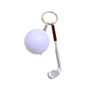 Miniature golf ball and club keychain pendant on a clean white background