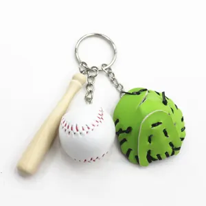 Close-up detail of a sports baseball keychain with a mini wooden bat and green glove
