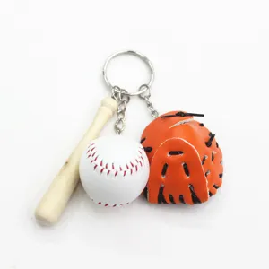 Detailed macro view of the three-in-one mini baseball, glove, and bat keychain charm