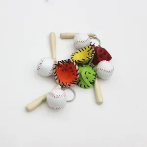 Detailed macro view of mini baseball keychains featuring wooden bats and colorful gloves
