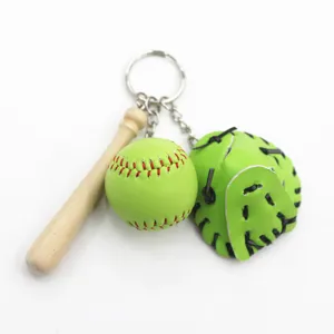 Detailed close-up view of mini green leather baseball glove and wooden bat keychain