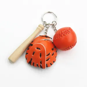 Detailed view of sports baseball keychain featuring mini wooden bat and orange leather glove charm