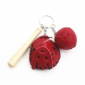Detailed view of red baseball glove ball and wooden bat keychain set for sports fans