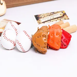 Detailed view of colorful baseball glove and mini wooden bat keychains set for bags.