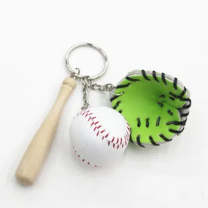 Close-up of sports themed keychain featuring a mini wooden bat, white baseball, and green glove