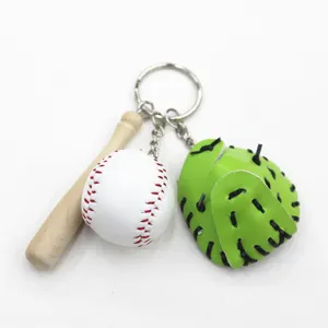 Detailed view of baseball keychain featuring mini wooden bat, white ball, and green glove.