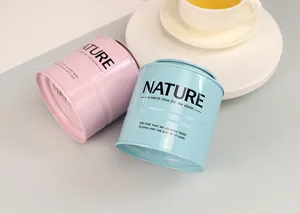 Barattolo tè cilindrico impilabile in latta, confezione regalo sigillata rosa e azzurro.