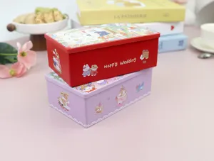Close-up of stacked red and purple square wedding candy tinplate boxes with cute rabbit designs