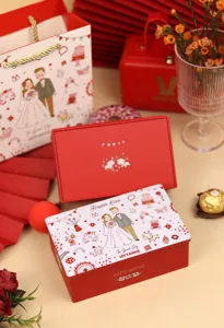 Vue détaillée d'une boîte à bonbons de mariage rouge avec illustration et chocolat Ferrero