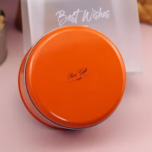 Caja redonda de hojalata naranja para galletas, dulces y bonita presentación de regalos.