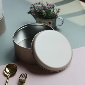 Caja redonda de hojalata monocolor para galletas y pastas, elegante envase de embalaje champán.