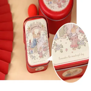 Close-up detail of wedding favor tin box featuring cute rabbit illustration and text.