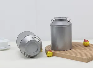 Silver tinplate tea canister with double handles, vintage milk can design for dry tea storage.