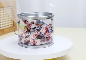 Primo piano dettagliato di un secchiello per caramelle trasparente in PVC e latta.