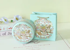 Dettaglio illustrazione animale in rilievo su scatola rotonda e borsa regalo blu