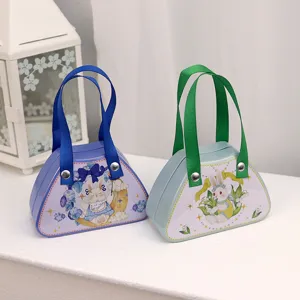 Schattige handtasvormige blikken doosjes met konijnenprints voor kindersnoepjes.