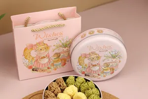Détail de la boîte en fer ronde et du sac cadeau avec illustration de lapin et biscuits.