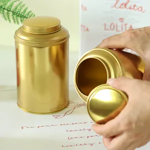 Gold metal tea caddy storage tin container with secure lid in hand view product display