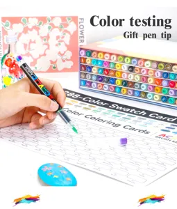 Detailed close-up of acrylic marker pen testing colors on swatch card with vibrant hues.