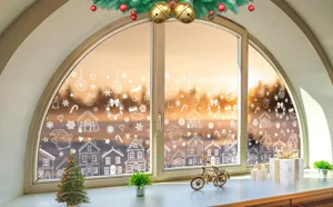 Detailansicht weißer Weihnachtsfensteraufkleber mit festlichen Haus- und Pinguinmustern