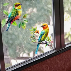 Detailed view of vibrant bird and branch window decals applied to a clear glass pane