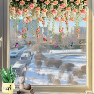 Close-up of butterfly and floral window decals applied to a bright glass surface.