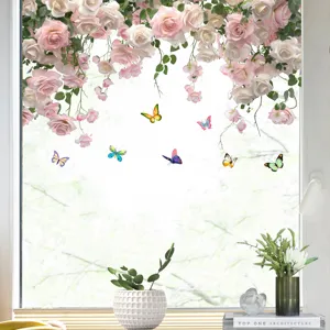 Close-up view of pink rose and colorful butterfly wall decals applied on a glass window