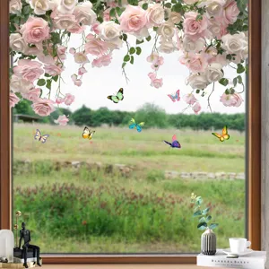 Macro detail showing vibrant flower and butterfly window stickers on a glass panel