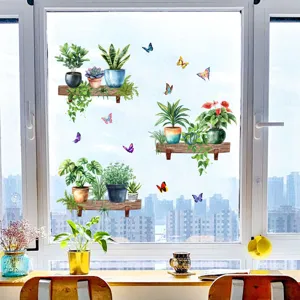 Detail view of green potted plant and butterfly stickers on a window glass