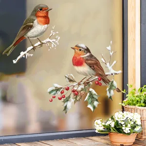 Detailed macro view of decorative robin bird window stickers on a snowy branch.