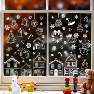 Festliche weiße Weihnachtsfensterbilder mit Schneeflocken und Häusern auf einer Glasscheibe.