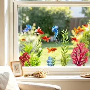 Detail of colorful goldfish and jellyfish static cling window stickers on a glass window.