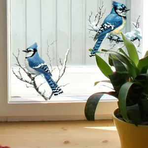 Detailed close-up view of realistic blue jay bird window stickers on snowy branches