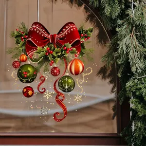 Close-up of festive Christmas window stickers with red bow and ornaments on glass.