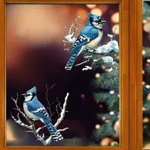 Detailed view of realistic Blue Jay bird window stickers on snowy branches for home decor