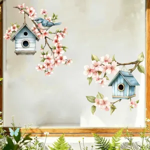Detailed view of watercolor birdhouse and cherry blossom window stickers on glass