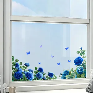 Detailed view of blue rose and butterfly static cling decals on a bright glass window.