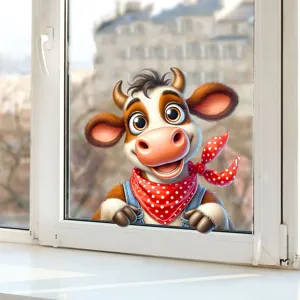Close-up of a cute cartoon cow window sticker applied to a white window frame glass