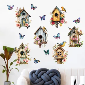 Detail showing birdhouse and butterfly wall stickers in a cozy living room setting.
