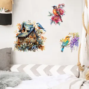 Close-up detail of watercolor bird and birdhouse wall stickers in a cozy bedroom setting